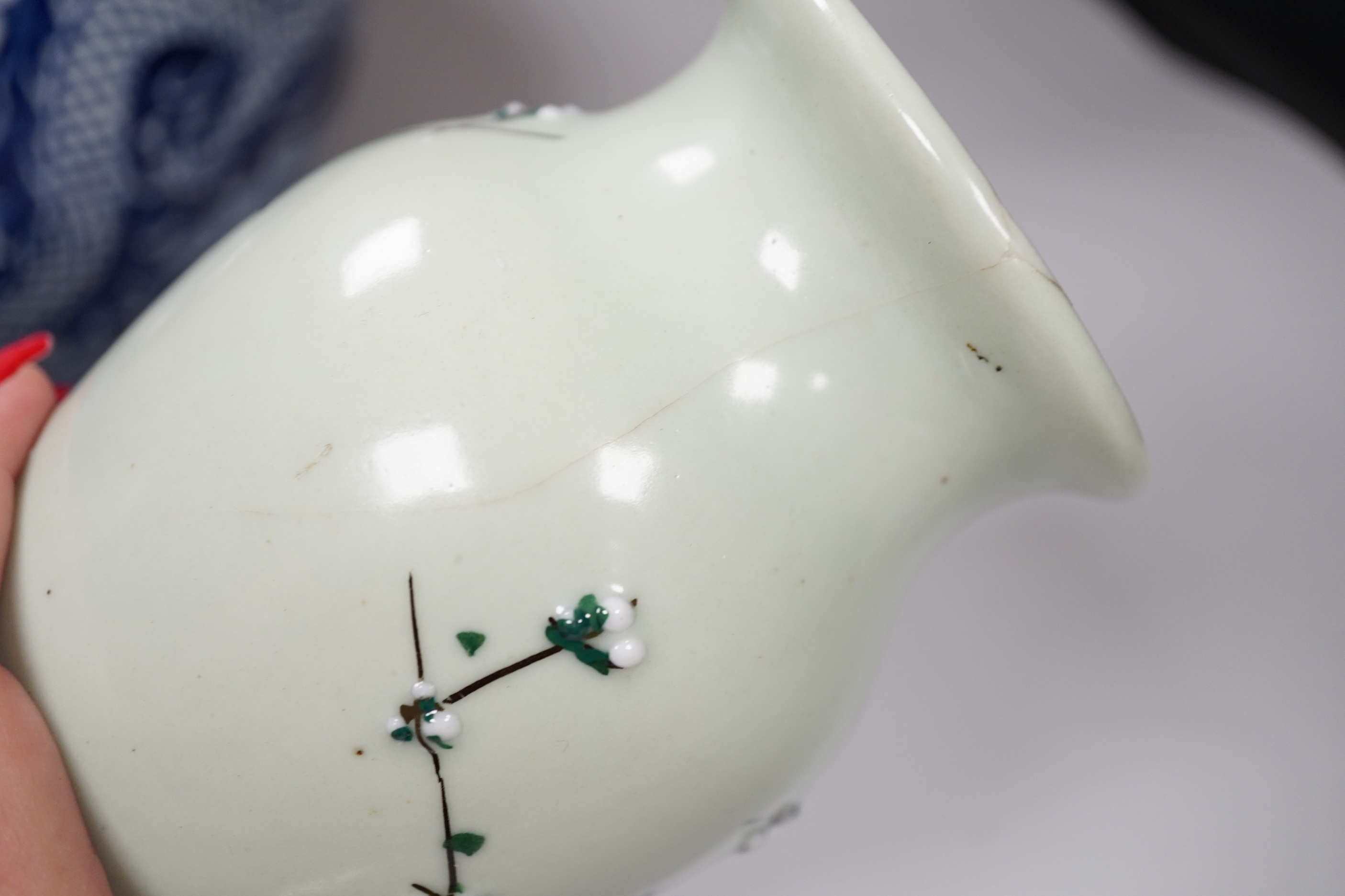 A group of Chinese ceramics including a celadon glazed vase, blue and white jar, white glazed figure and a jardiniere